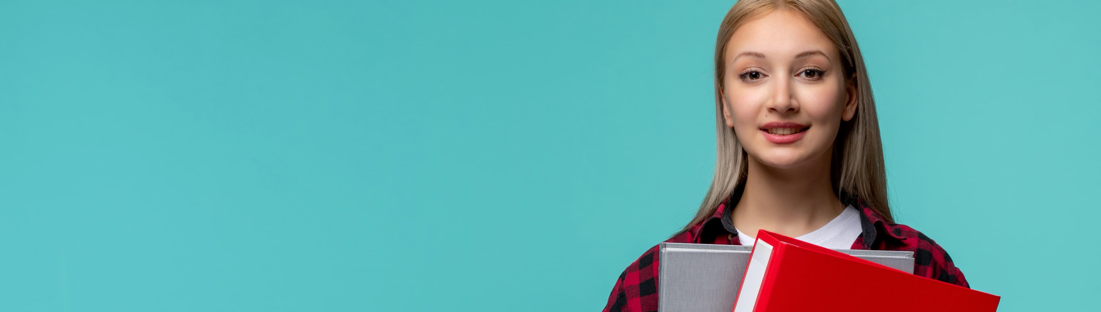 1765801525800-HERO-international-students-day-young-cute-girl-red-checked-shirt-happily-holding-file-folders.jpg