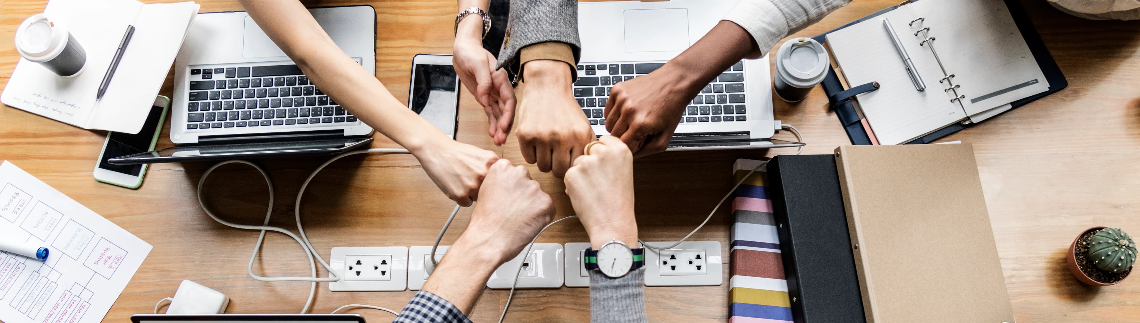 1766066273715-HERO-colleagues-giving-fist-bump.jpg